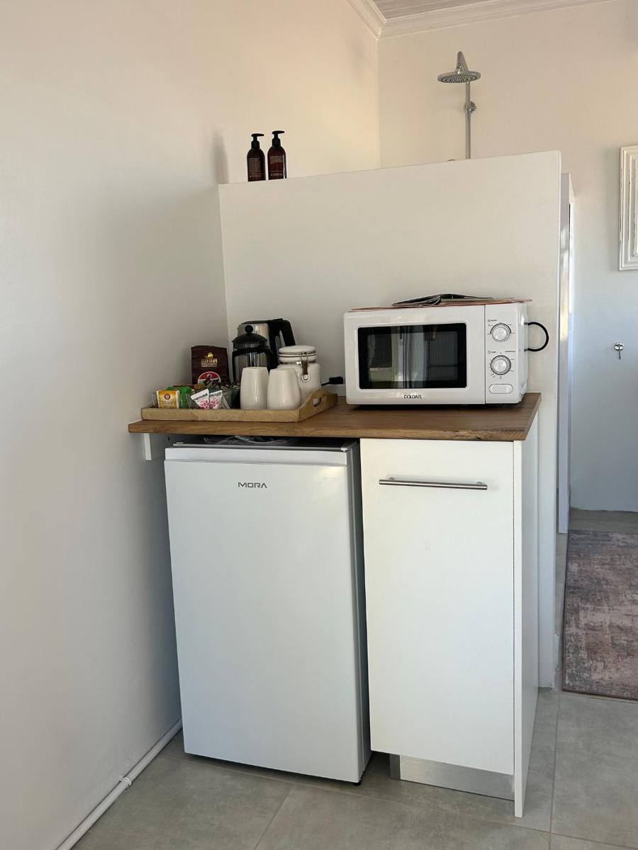 Kitchenette with bar fridge, microwave and coffee station