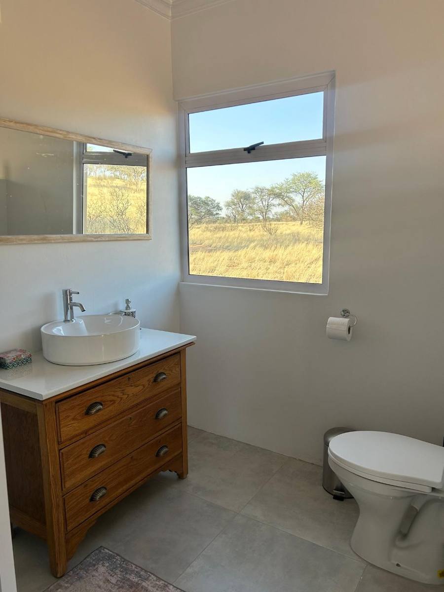 Bathroom vanity with a window onto the bush